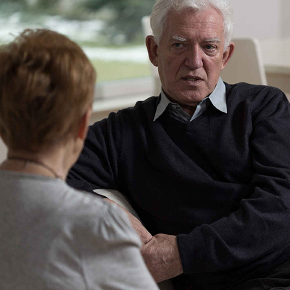 Man talking to woman about something such as voice issues