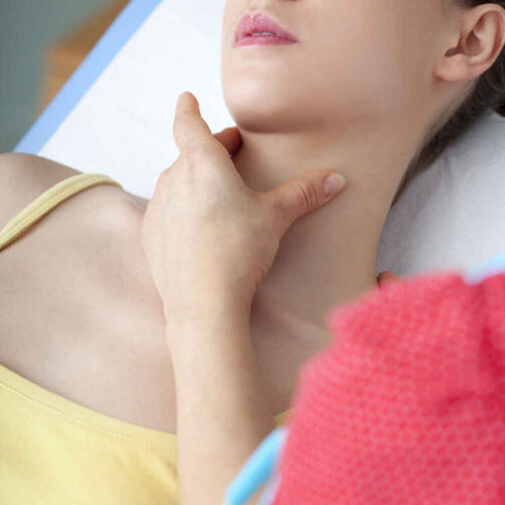 Person pressing against another person's neck to check for issues